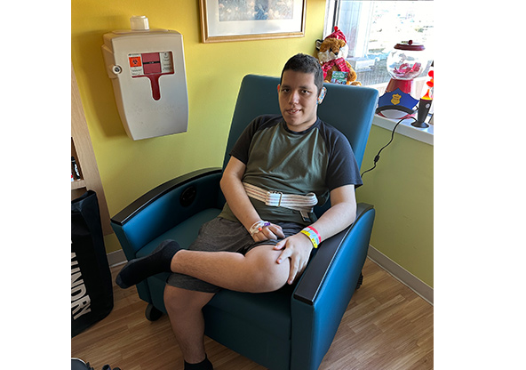 Samuel Trejo sitting in a chair at CHRISTUS Children's
