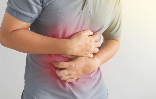Man holding his stomach that's in pain