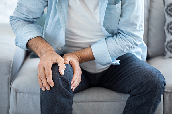 A man holding his knee