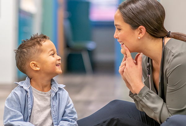 therapist showing child speech techniques