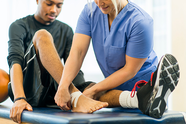 guy getting his ankle wrapped