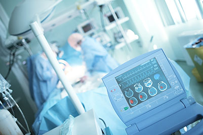 Two neurosurgeons in an operating room with medical devices